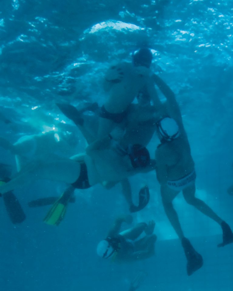 Players are shown playing underwater rugby.