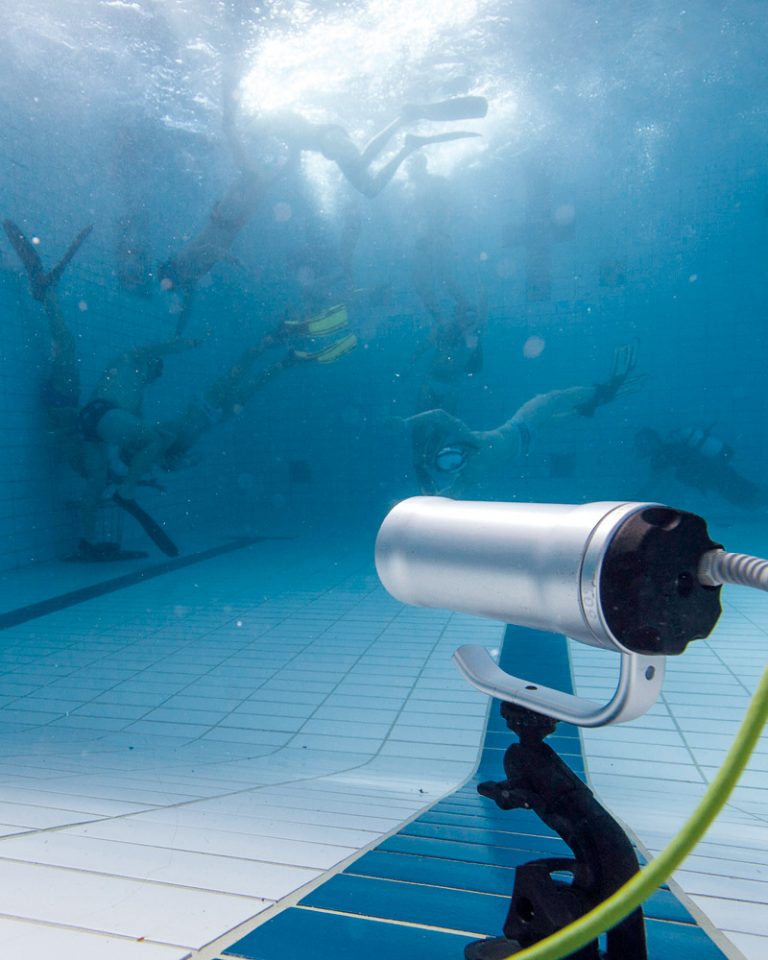 Players are shown playing underwater rugby.