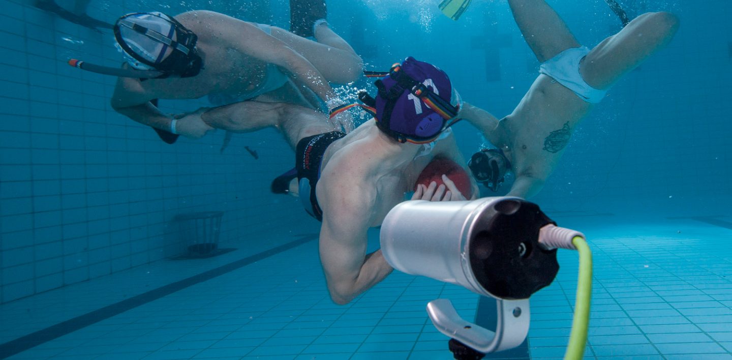 Players are shown playing underwater rugby.