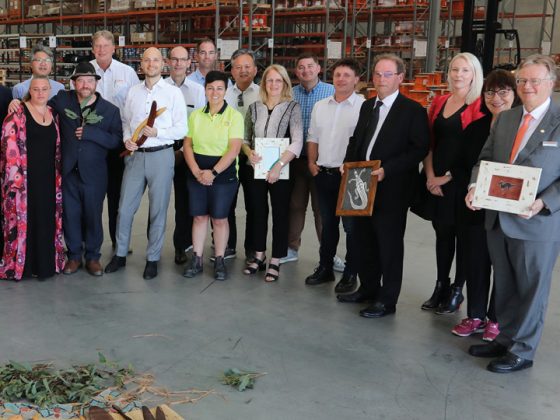 The picture shows the LAPP Australia team with Andreas and Alexander Lapp in the factory hall.