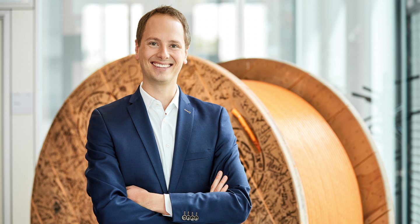 Matthias Lapp, CEO & Managing Director of U.I. LAPP GmbH stands in front of a cable drum.