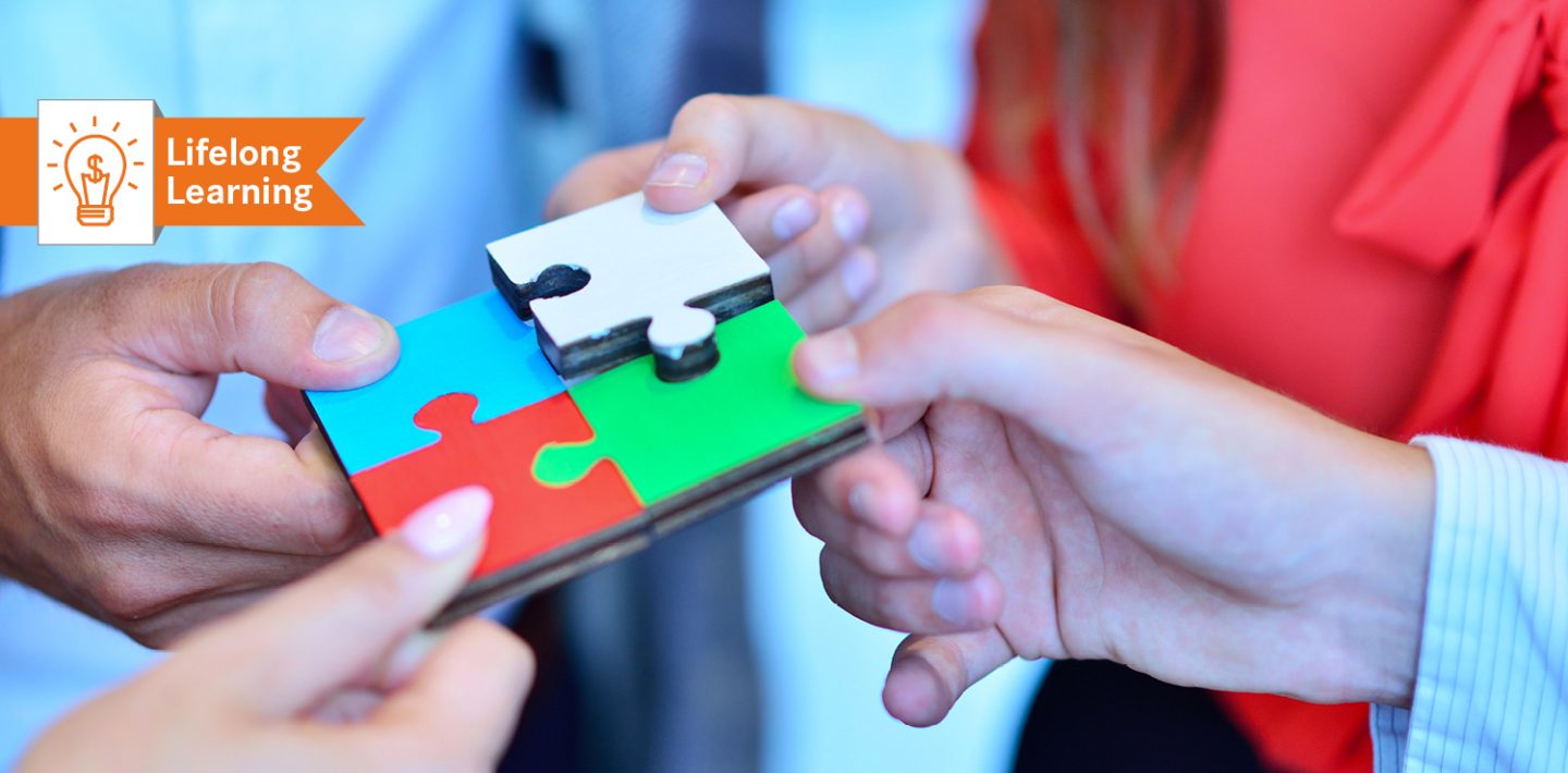 The picture shows the hands of four people putting together a puzzle with four pieces.
