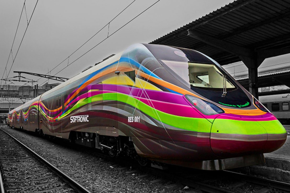 The picture shows a Softronic locomotive in a train station.