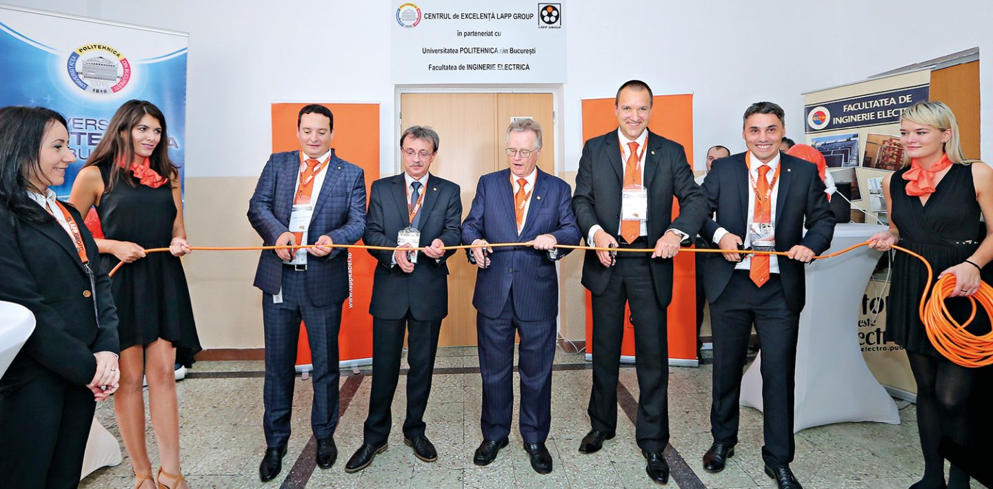 The picture shows the opening of the LAPP Center of Excellence, in September 2016, at the Faculty of Electrical Engineering of the Politehnica University of Bucharest, where five men (including) Andreas Lapp cut a cable.